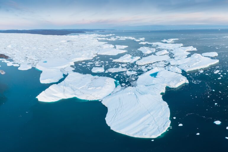 Glaciers drone aerial image from above - climate change and global warming. Glaciers from a melting iceberg in Ilulissat, Greenland. The icy landscape of the Arctic nature in the UNESCO world